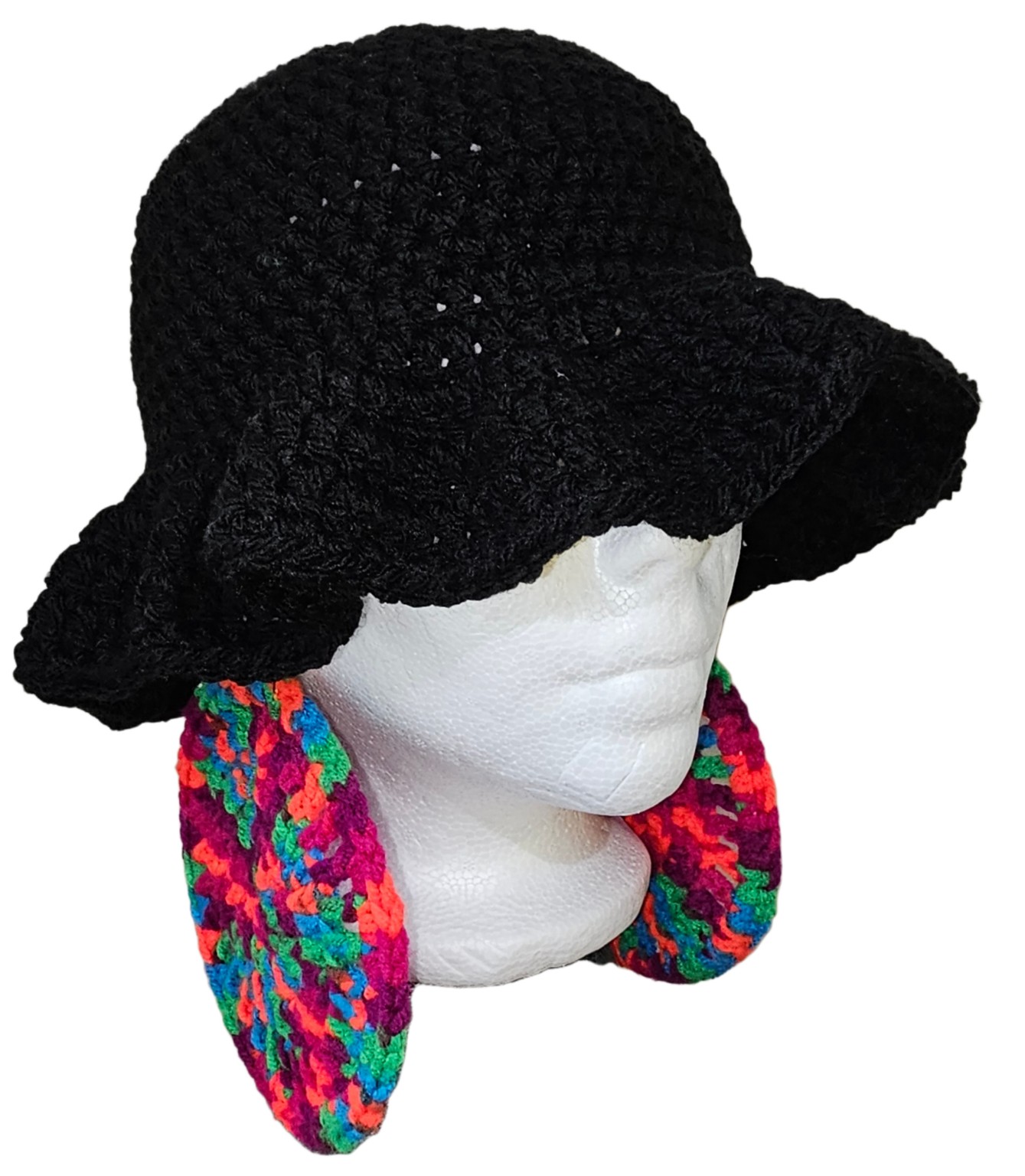 Black crochet hat shown from a three-quarter angle with colorful crochet earrings
