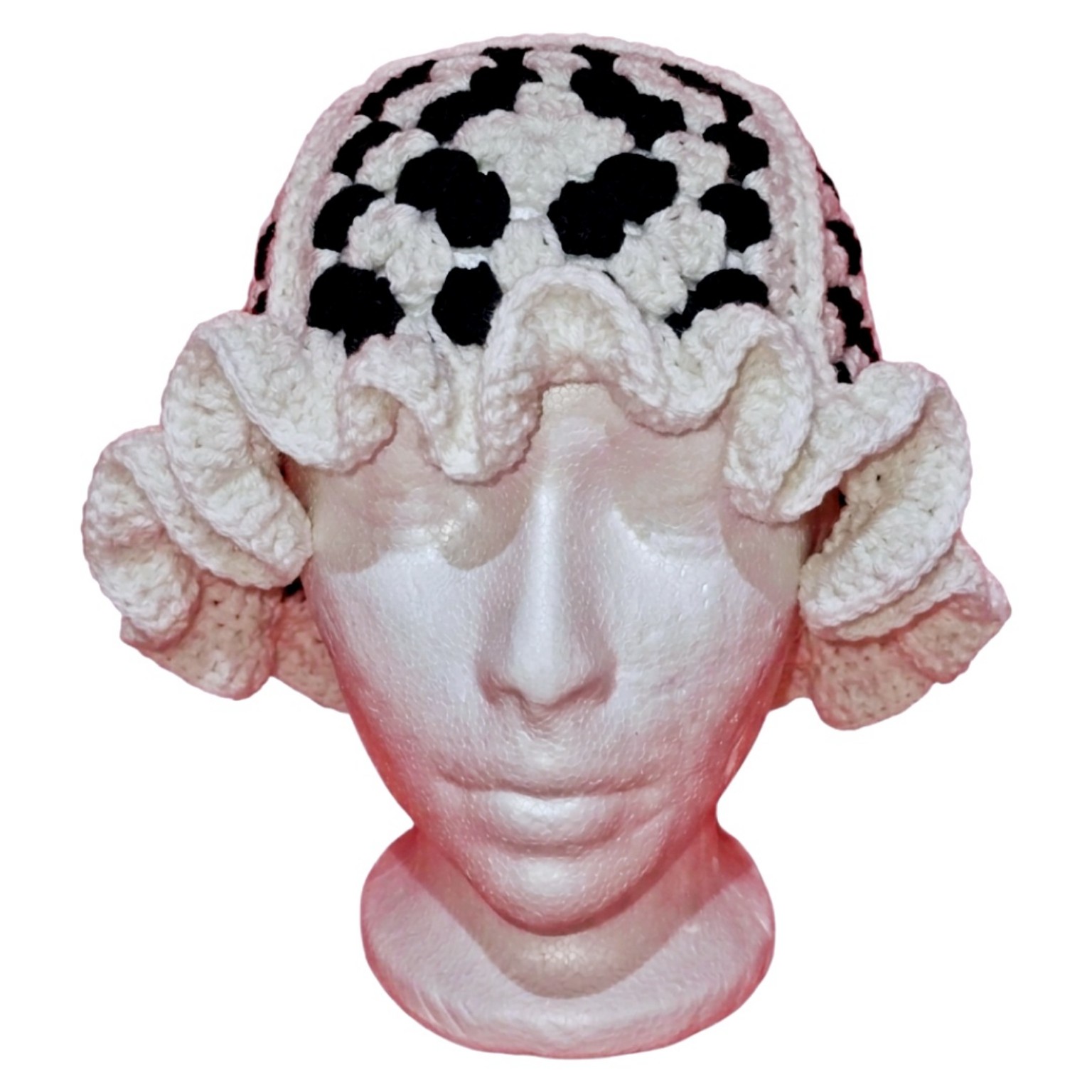 Black and white granny-stitch crochet hat with a softly ruffled brim, front view