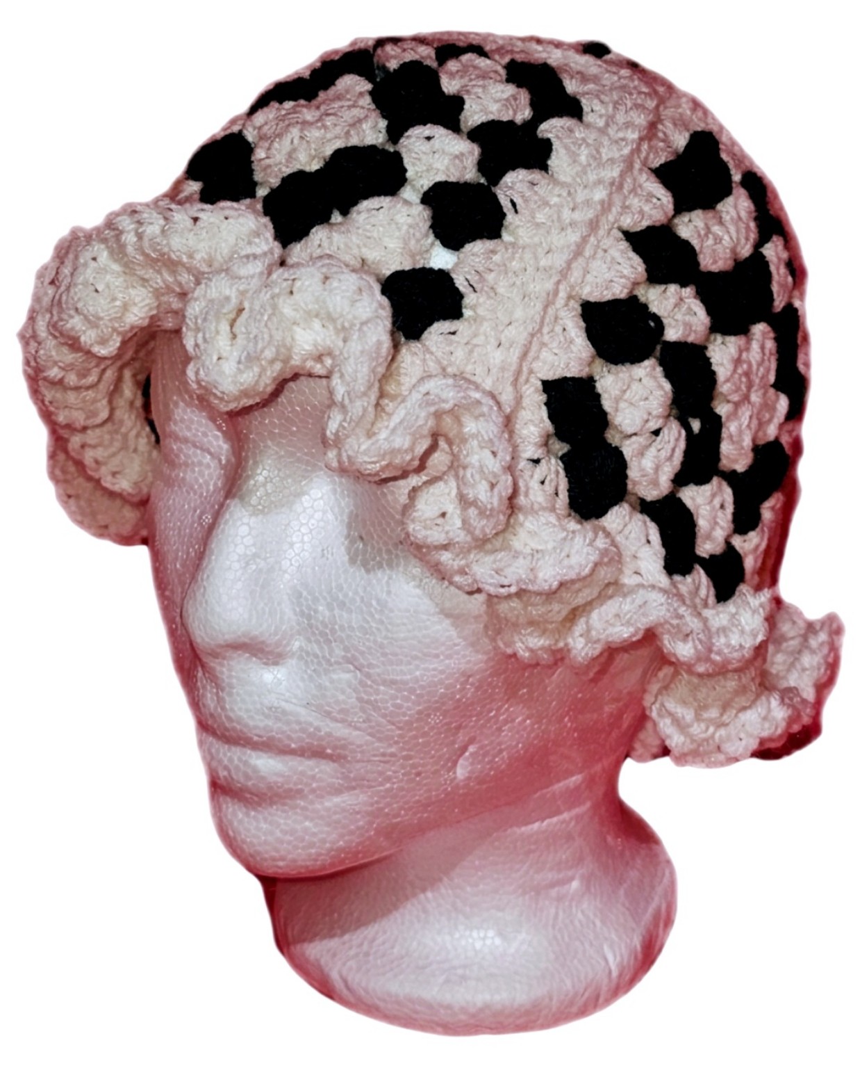 Black and white granny-stitch crochet hat with a softly ruffled brim, side view